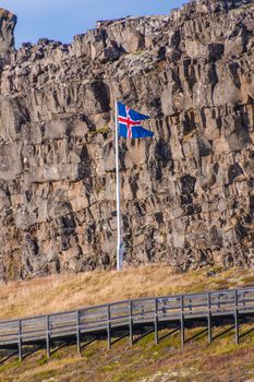 Thingvellir National Park in Iceland icelandic flag in front of Loegberg