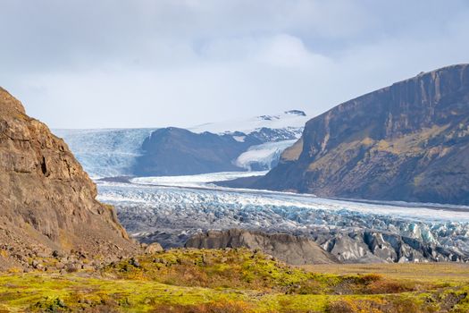 Vatnajoekull glacier in Iceland eternal ice deep blue flowing down the mountain