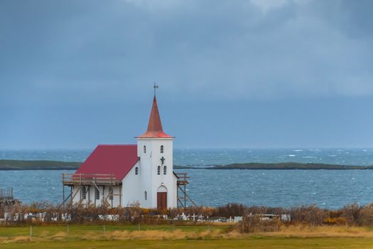 Wooden church in Iceland close to Atlantic coast during stormy weather