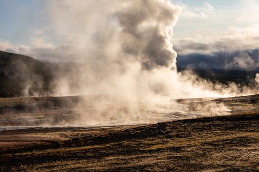 Old Faithful, Yellowstone exploding hot smoke before eruption in
