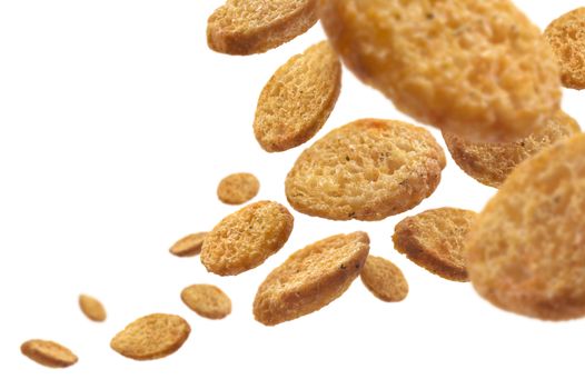 Bread croutons levitate on a white background