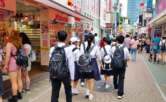 TOKYO, JAPAN - MAY 29, 2018. Japanese school student walking in Harajuku street.