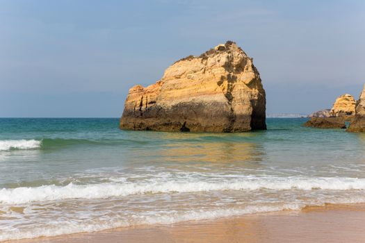 the famous beach of Praia da Rocha in Portimao. This beach is a part of famous tourist region of Algarve.