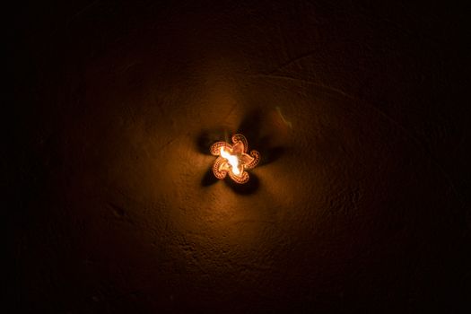 Glowing clay lamp in dark night - Happy Diwali, Light festival, Illuminated lights