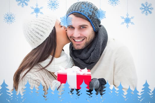Composite image of attractive young couple in warm clothes holding gift