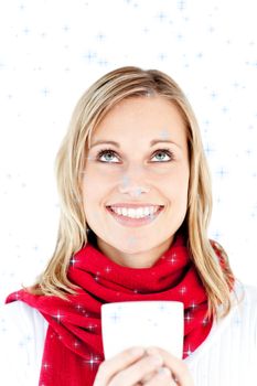 Composite image of blissful young woman holding a cup wearing a scarf