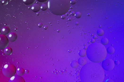 Oil drops on water surface color abstract background. blue and p