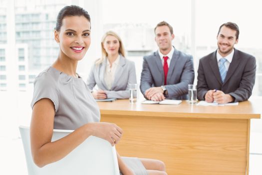 Woman in front of corporate personnel officers