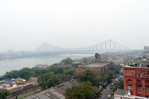 Panoramic riverside Kolkata city life in a winner foggy evening. Ariel view Kolkata in Hooghly riverbank West Bengal India South Asia Pacific. Photography from rooftop.
