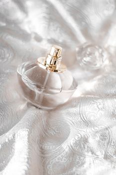 Perfume bottle with aromatic floral scent, luxury fragrance