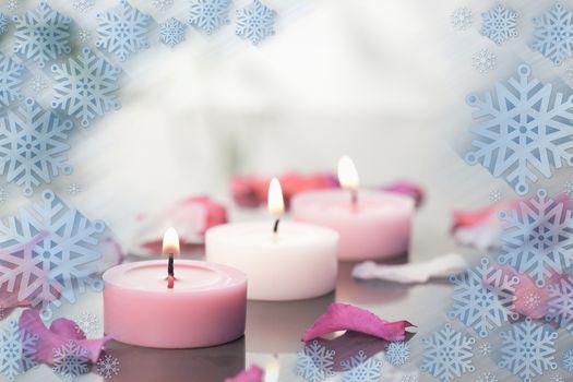 Composite image of lighted candles and petals