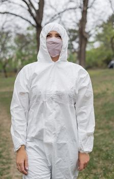 Woman in black mask and white protective suit