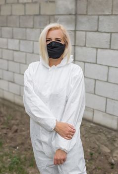 Woman in black mask and white protective suit
