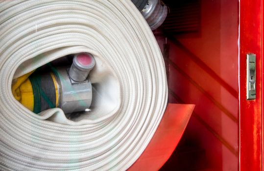 Roll of canvas hose in the emergency firefighting box