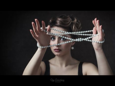 young brunette model girl and actress with pearl beads, black an