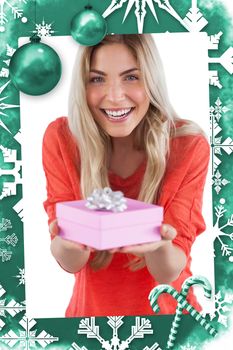 Composite image of young woman offering gift