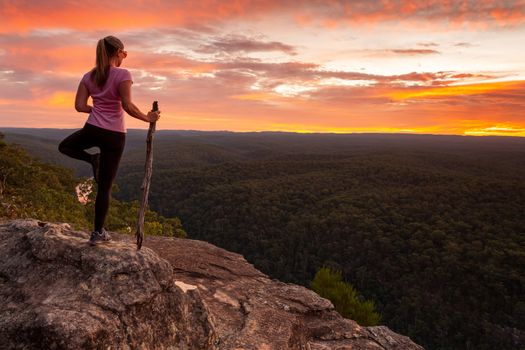 Woman mountain top serenity yoga native style while watching magnificent sunset