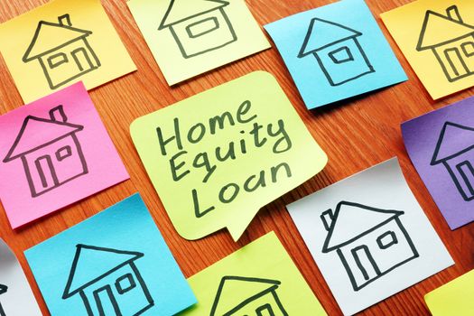 Home equity loan phrase on the memo stick. Mortgage concept.