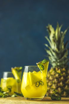 Two glasses of spicy pineapple jalapeno mezcalita or margarita f