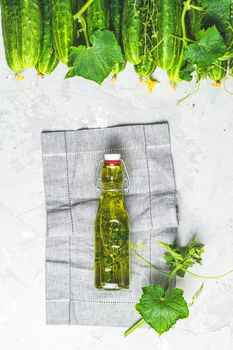 Bottle of olive oil with thyme on linen cloth with green fresh c
