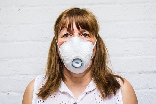 face of a woman wearing surgical mask during Covid 19