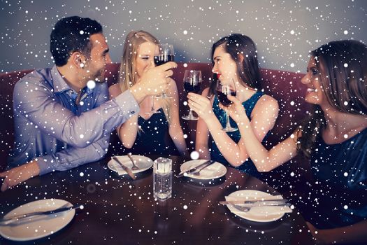 Composite image of smiling friends clinking wine glasses