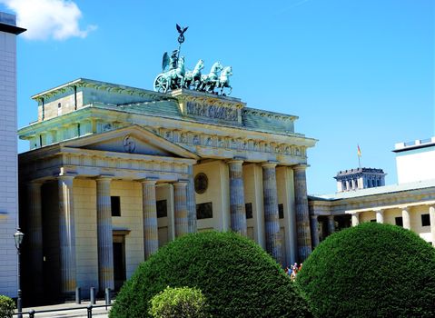 Brandenburg gate with bushes and blue sky