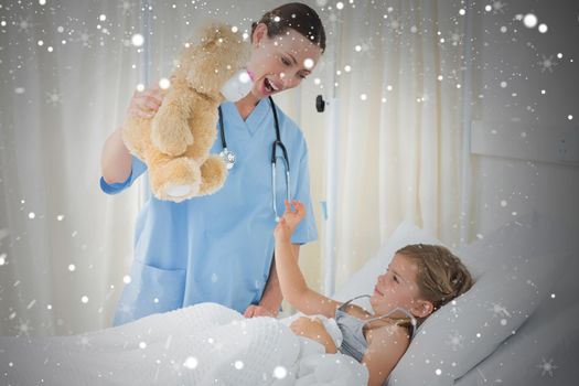 Composite image of doctor entertaining sick girl with teddy bear