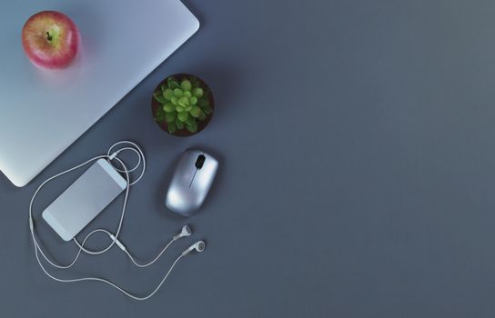 Grey desktop with mobile devices in flat lay format for telework