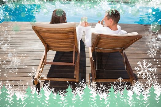 Couple toasting champagne by swimming pool