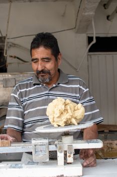 man selling dough in nixtamal mill