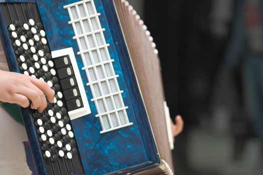 Accordion in the hands of a musician, close-up view.