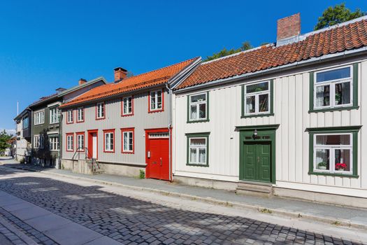 Colorful buildings on streets with cobbled pavement. Scandinavian style of architecture. Trondheim, Norway