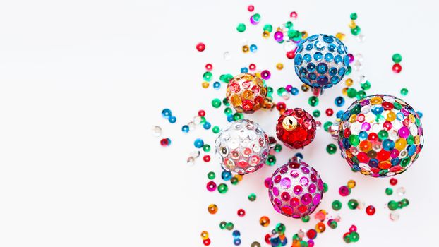 Christmas and New Year background with decorations - bright balls, hand made with colorful sparkling spangles. Place for text.