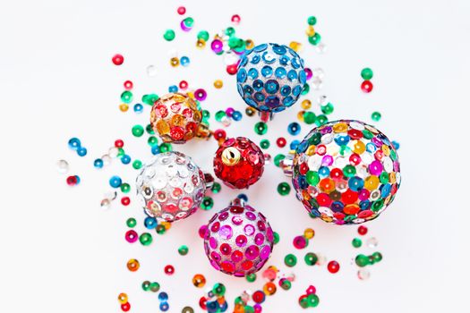Christmas and New Year background with decorations - bright balls, hand made with colorful sparkling spangles.