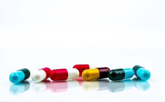 Colorful antibiotic capsule pills on white background. Pharmaceu