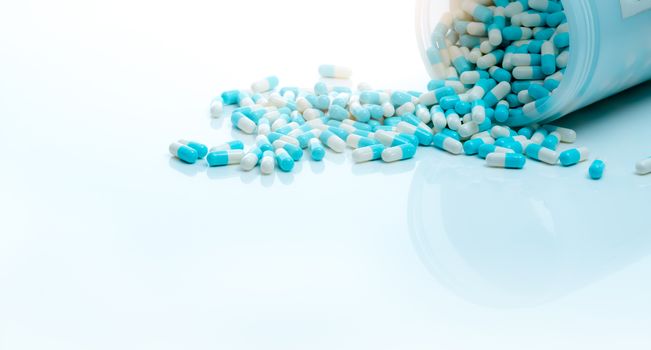 Blue-white antibiotic capsule pill and capsule pills bottle. Ant