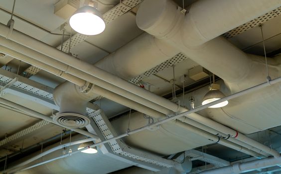 Air duct, wiring and plumbing in the mall. Air conditioner pipe,
