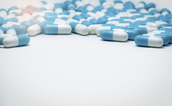 Blue and white capsule pills on white background. Antibiotics dr