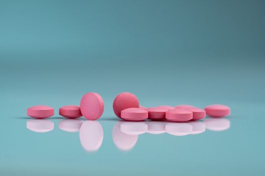 Round pink tablets pill on gradient background. Vitamins and min