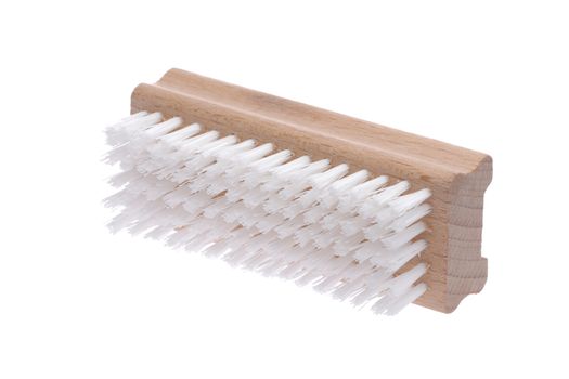 Retro wood nail brush with long bristles inclined on a white bac