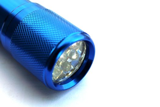 Details of a led flashlight on white background