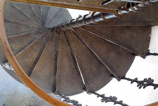 Metal stairs spiralling down, ancient architecture details