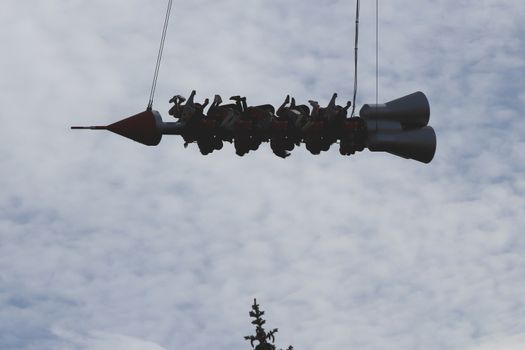 Carousel rocket with peoples riding sky. Amusement park Divo-island. Saint-Petersburg.