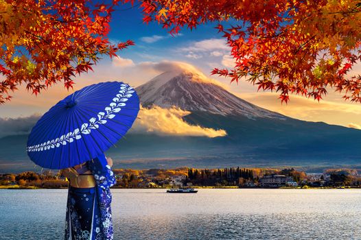 Asian woman wearing japanese traditional kimono at Fuji mountain. Autumn at Kawaguchiko lake in Japan.
