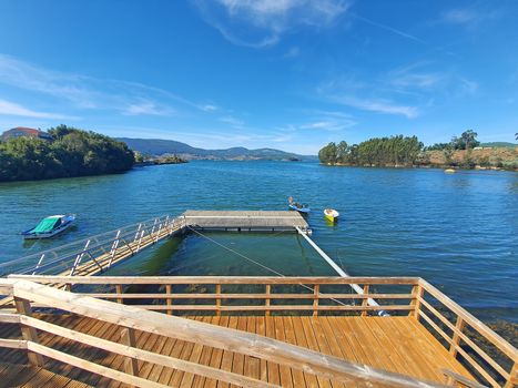 Wooden dock for fishing and sport boats, Ria of Vigo estuary coast.
