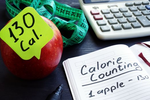 Calorie count concept. Apple and among calories.