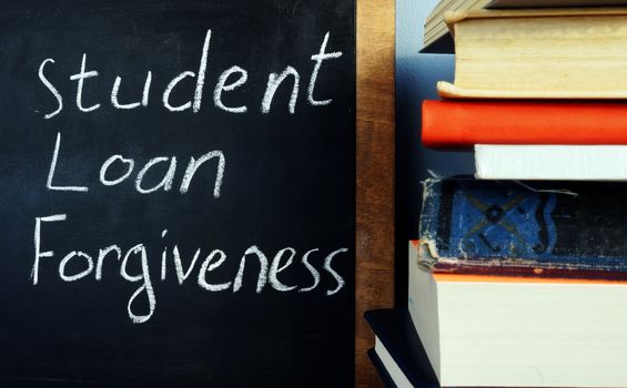 Student loan forgiveness handwritten on a blackboard.