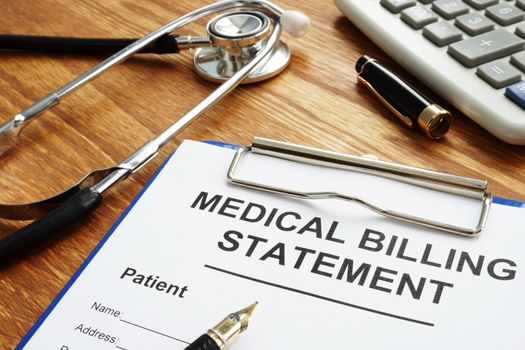 Medical billing statement, pen and stethoscope. Affordable health care.
