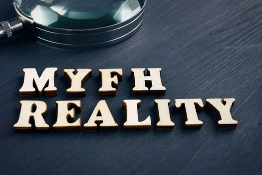 Word myth and reality with magnifying glass. Fake news concept.